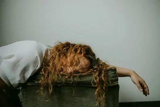 woman suffering depression and sleeping on a desk